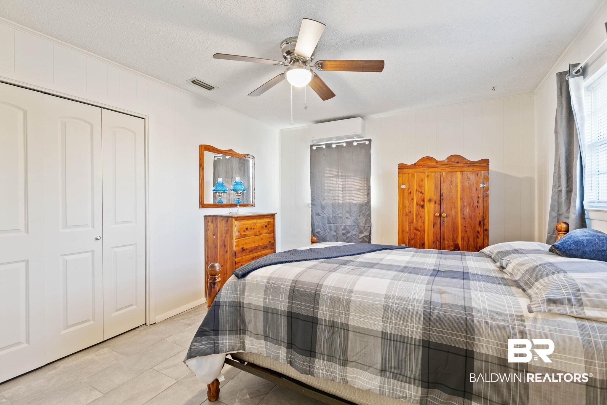 21267 Loop Road Andalusia, AL 36421 - Photo 41 of 72 Bedroom with a ceiling fan, a closet, and light tile patterned floors