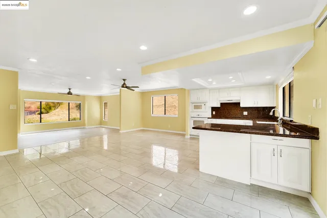 a large kitchen with a sink and cabinets