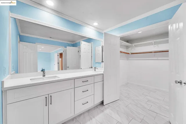 a bathroom with double sink and a mirror