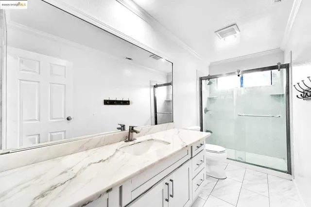 a view of a big room with wooden floor and windows