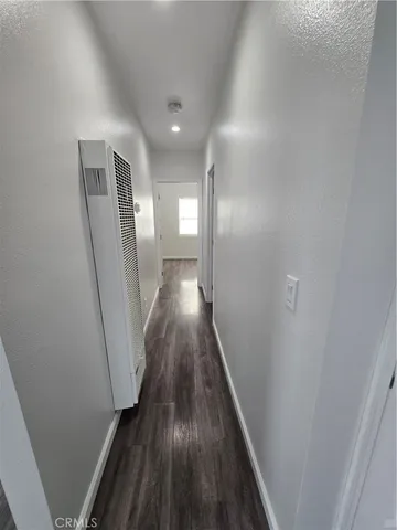 a view of gallery with wooden floor