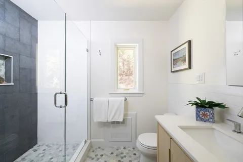 a bathroom with a sink toilet and shower