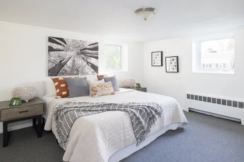 a bedroom with bed and window