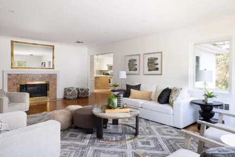 a living room with furniture and a fireplace