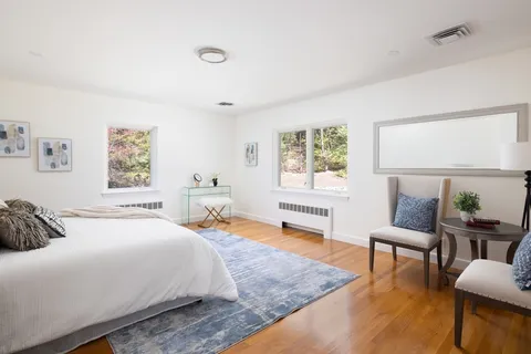 a bedroom with a bed a table and chair