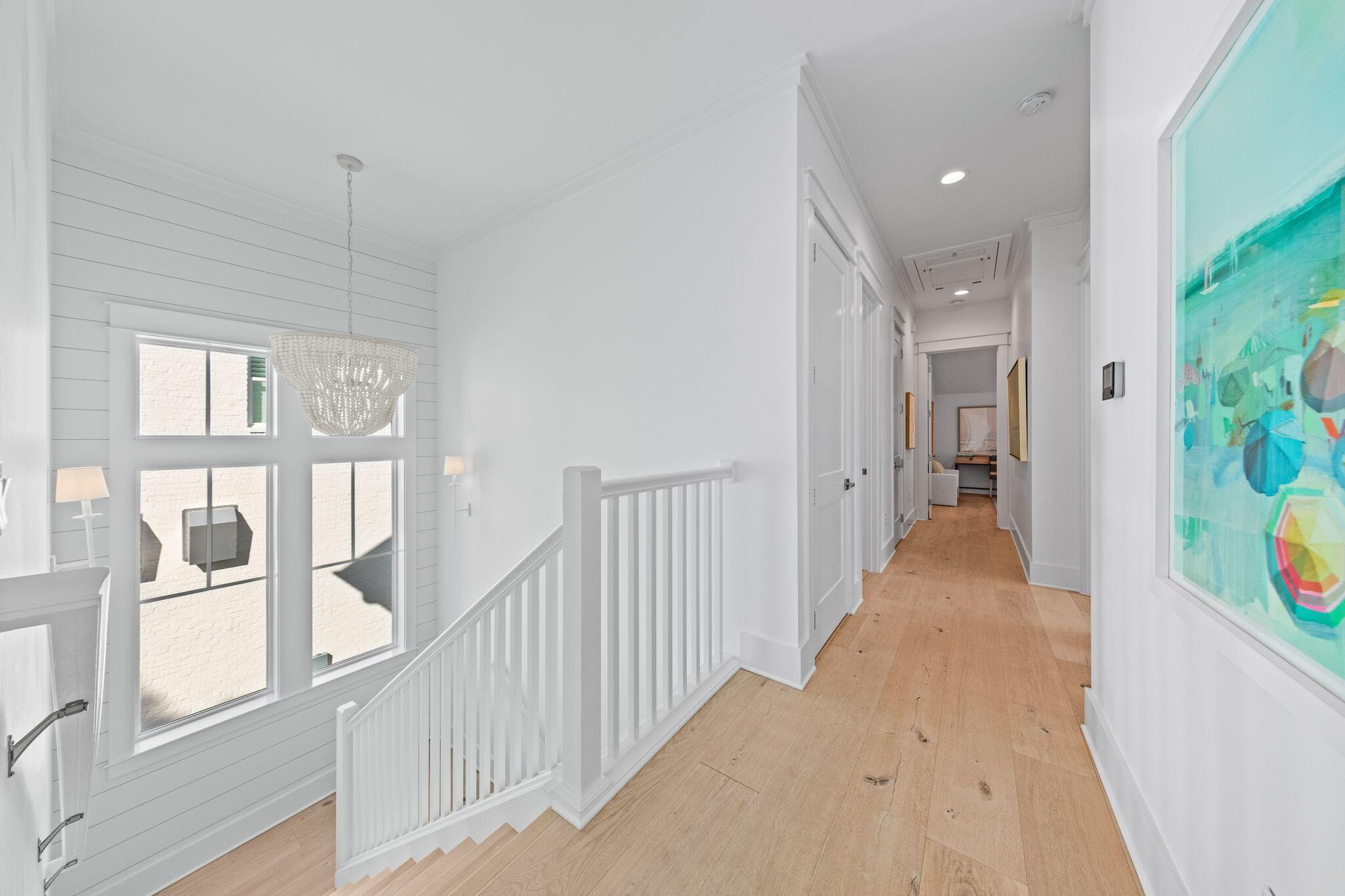 58 White Cottage Road Santa Rosa Beach, FL 32459 - Photo 60 of 84 a view of a hallway with wooden floor and windows