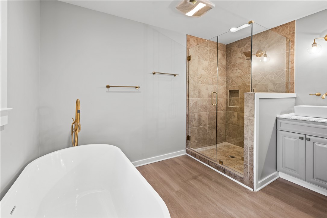 309 Woodland Way Clemson, SC 29631 - Photo 20 of 43 This serene bathroom offers a spa-like escape with a spacious shower and elegant soaking tub.