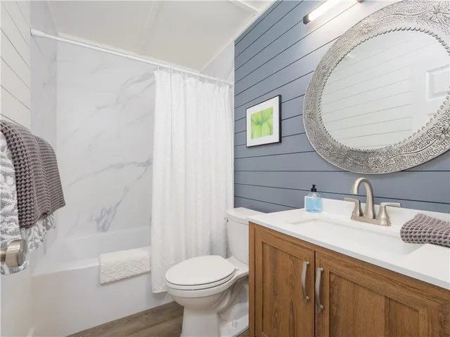 a bathroom with a sink a toilet and tub