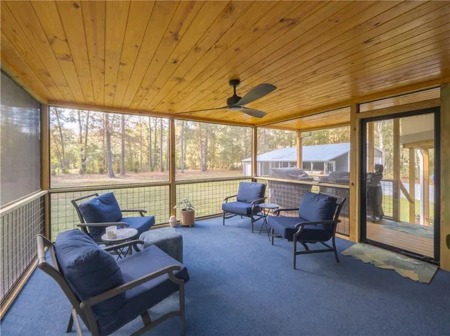 a living room with furniture and a floor to ceiling window