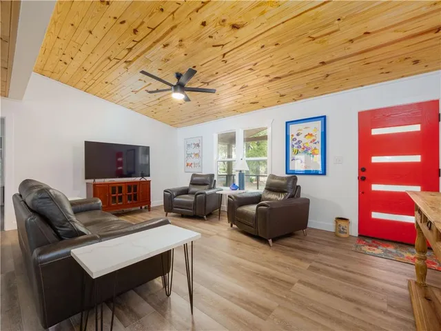 a living room with furniture and wooden floor