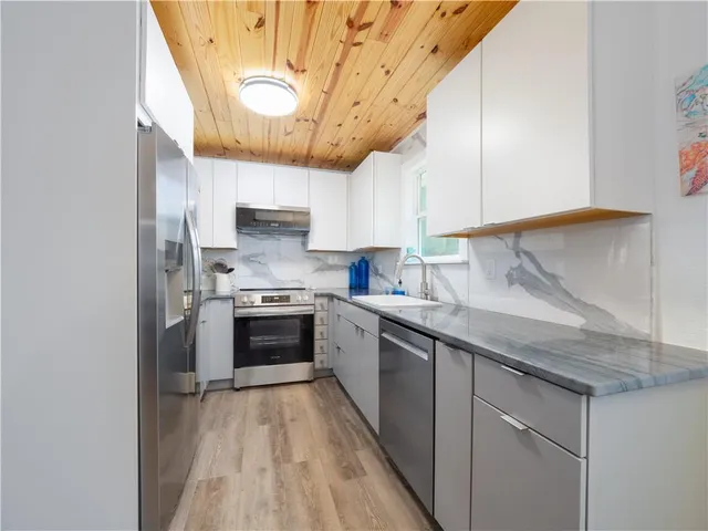 a kitchen with a sink stove and cabinets