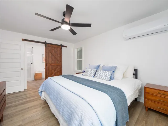 a bedroom with a bed and a chandelier