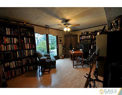 19 Barton Road Old Bridge, NJ 08857 - Photo 3 of 15 a living room with furniture and a flat screen tv