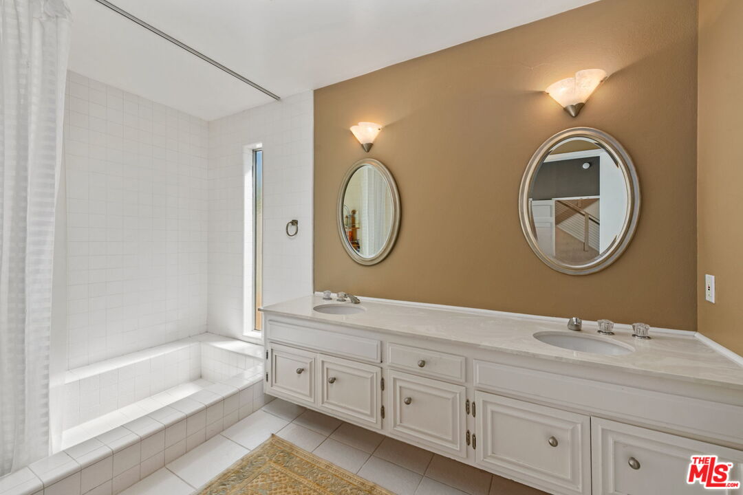 2601 Cordelia Road Los Angeles, CA 90049 - Photo 12 of 43 a bathroom with a double vanity sink and a mirror