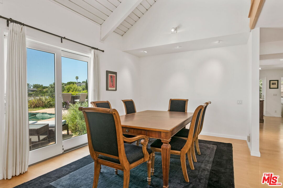 2601 Cordelia Road Los Angeles, CA 90049 - Photo 13 of 43 a view of a dining room with furniture wooden floor and front door