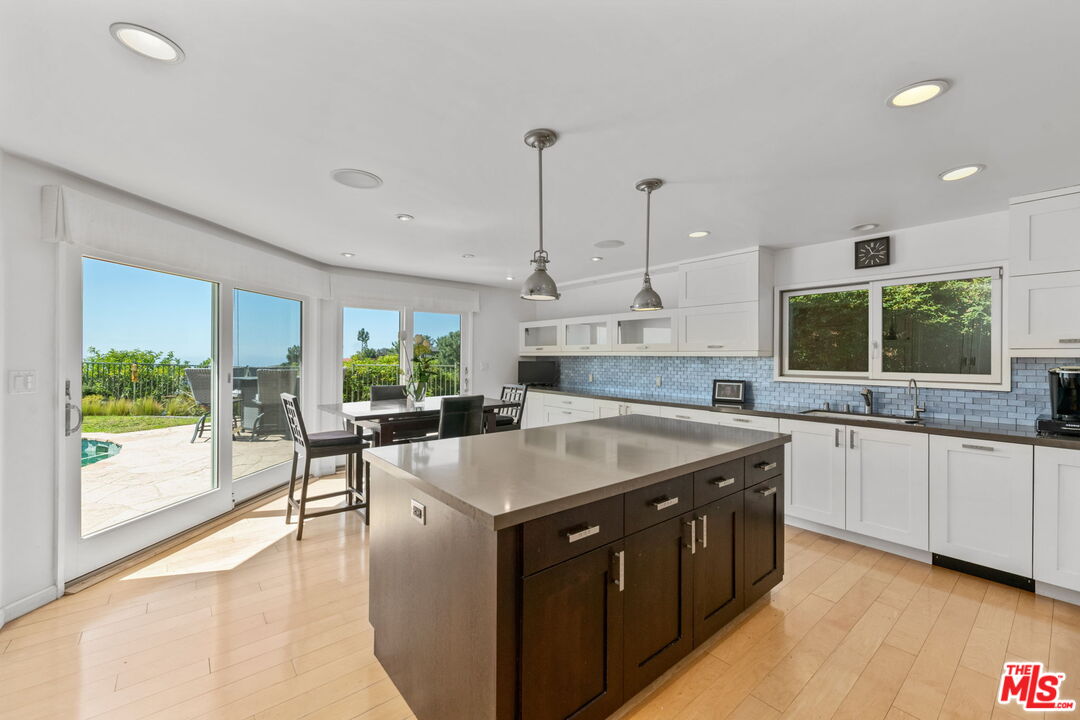 2601 Cordelia Road Los Angeles, CA 90049 - Photo 17 of 43 a kitchen with a stove a sink and a refrigerator