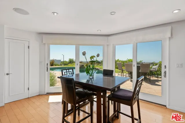 a dining room with furniture and wooden floor