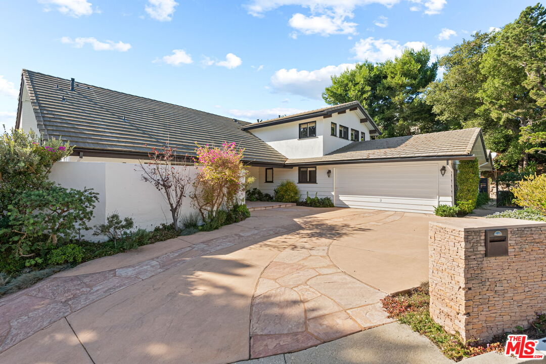 2601 Cordelia Road Los Angeles, CA 90049 - Photo 2 of 43 a white house with tree in front of it