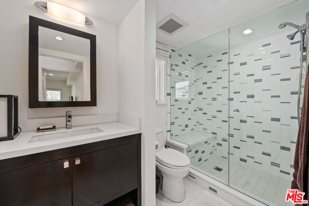 2601 Cordelia Road Los Angeles, CA 90049 - Photo 24 of 43 a bathroom with a sink and a mirror