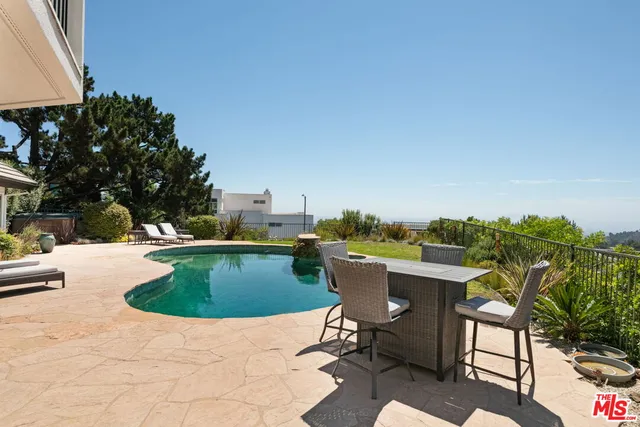 a view of a swimming pool with a lounge chair