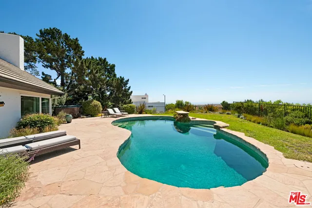 a view of a swimming pool with a garden