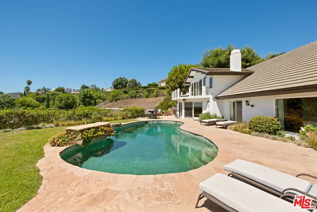 a view of a swimming pool with a outdoor seating