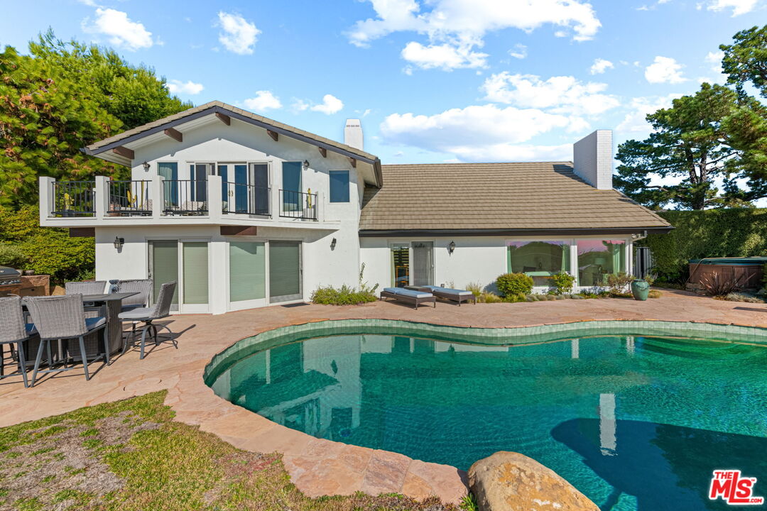 2601 Cordelia Road Los Angeles, CA 90049 - Photo 5 of 43 a front view of a house with swimming pool having outdoor seating
