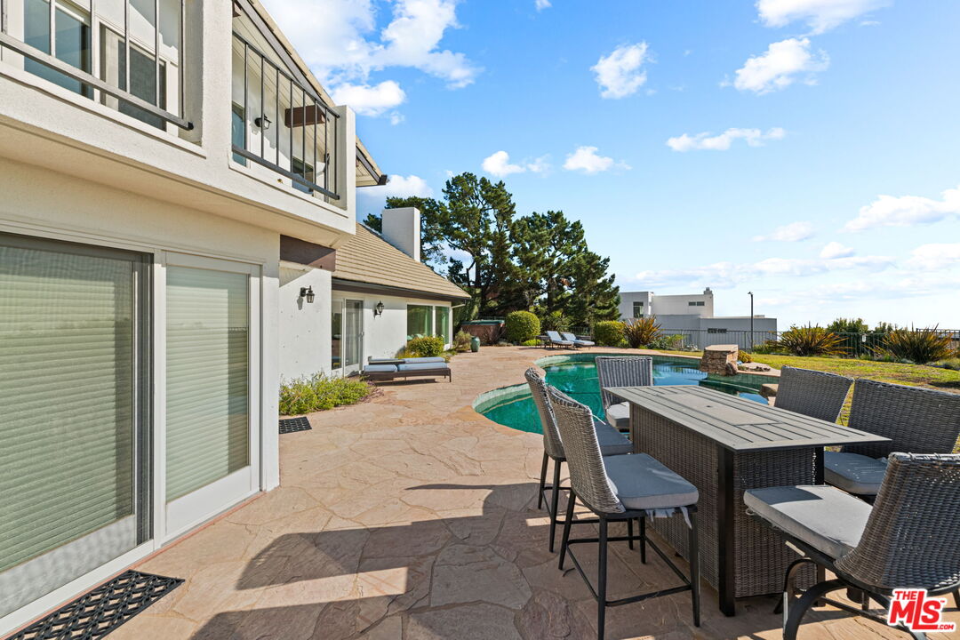 2601 Cordelia Road Los Angeles, CA 90049 - Photo 6 of 43 a view of a patio with a table and chairs