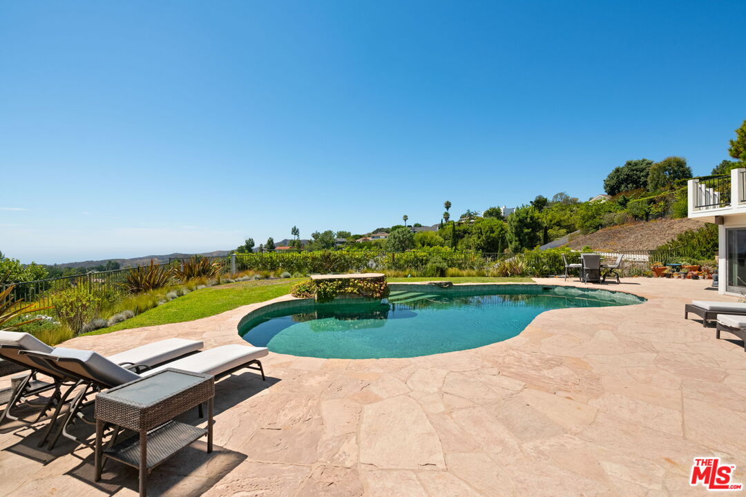 2601 Cordelia Road Los Angeles, CA 90049 - Photo 7 of 43 an aerial view of a swimming pool with a yard