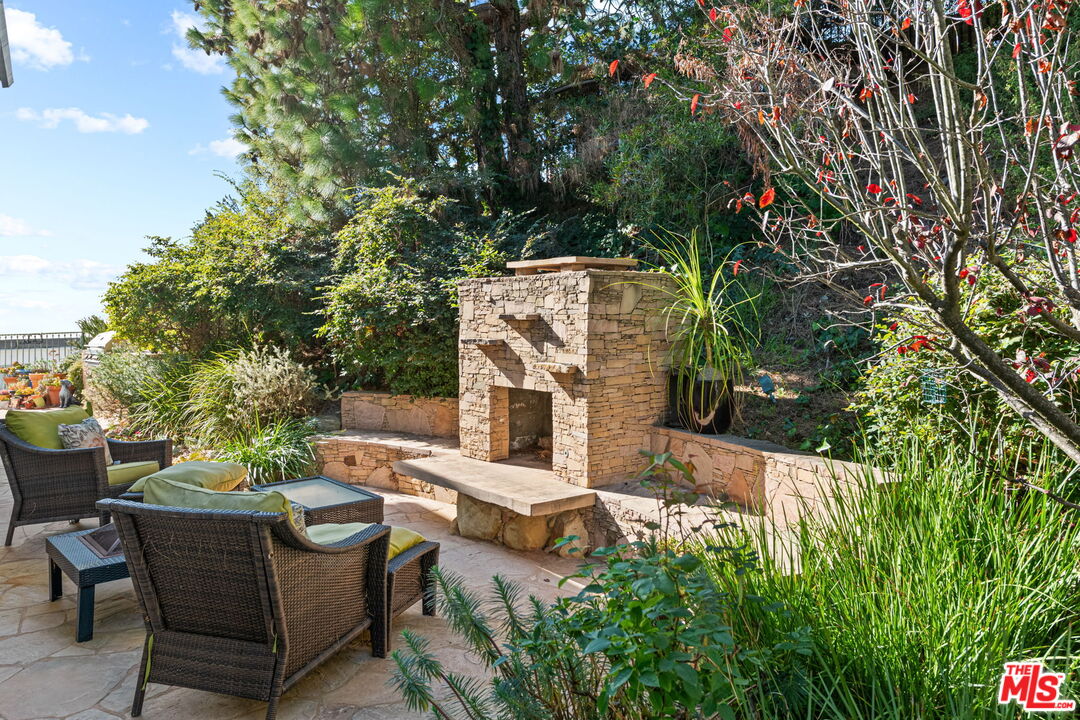 2601 Cordelia Road Los Angeles, CA 90049 - Photo 9 of 43 a view of a patio with table and chairs and potted plants