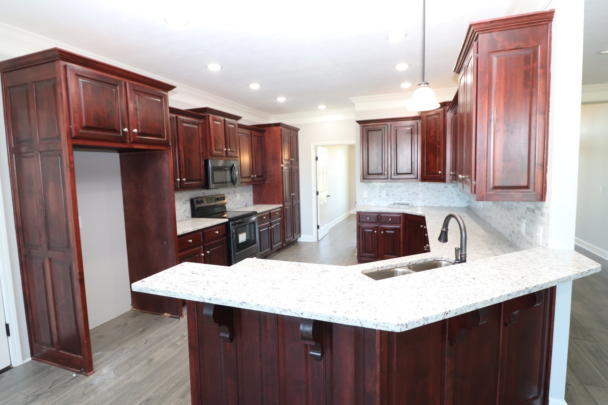 1180 Coleytown Road Lafayette, TN 37083 - Photo 12 of 42 a kitchen with stainless steel appliances a sink dishwasher a refrigerator a stove with wooden cabinets and floor