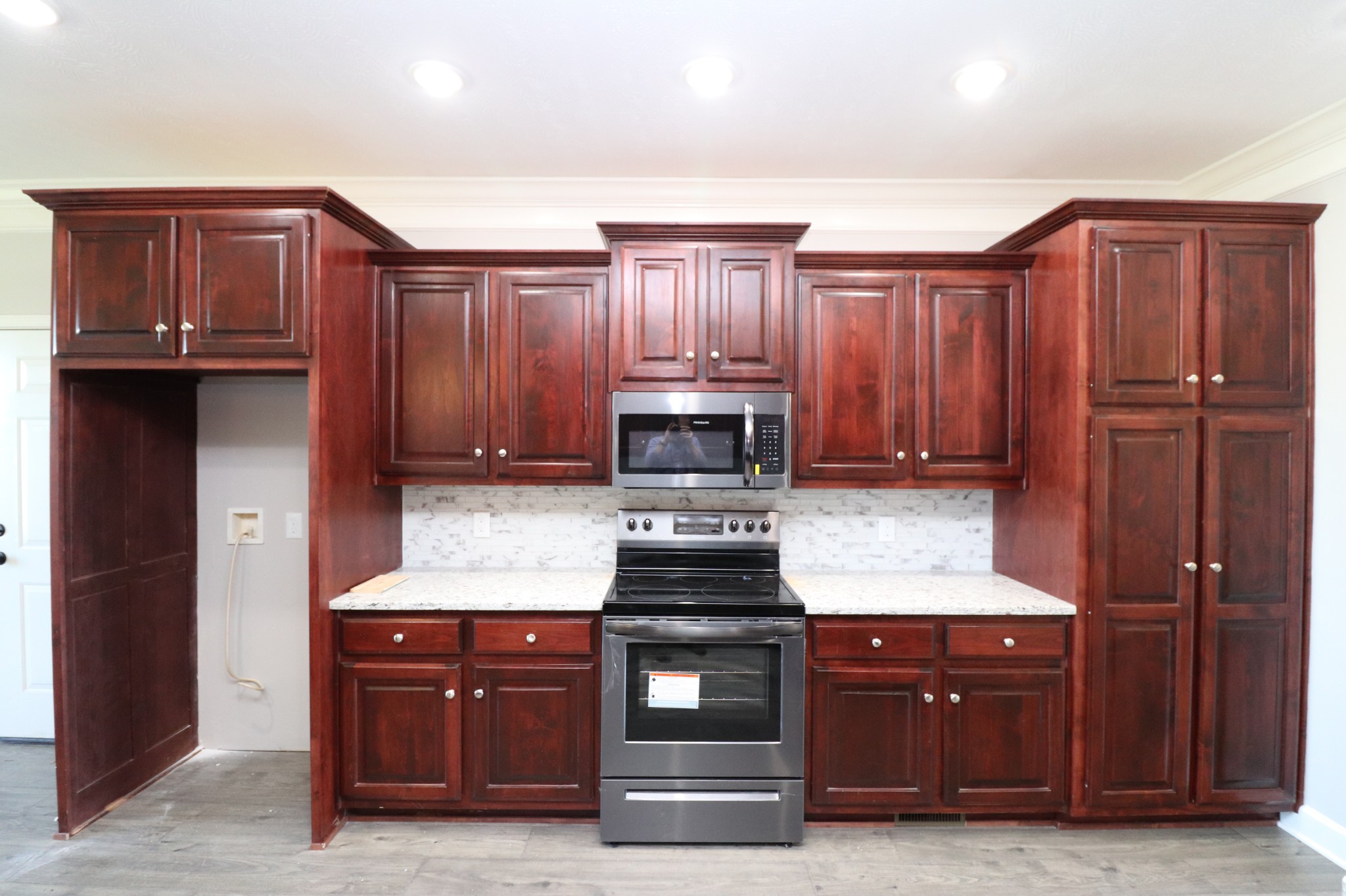 1180 Coleytown Road Lafayette, TN 37083 - Photo 13 of 42 a kitchen with granite countertop wooden cabinets and stainless steel appliances
