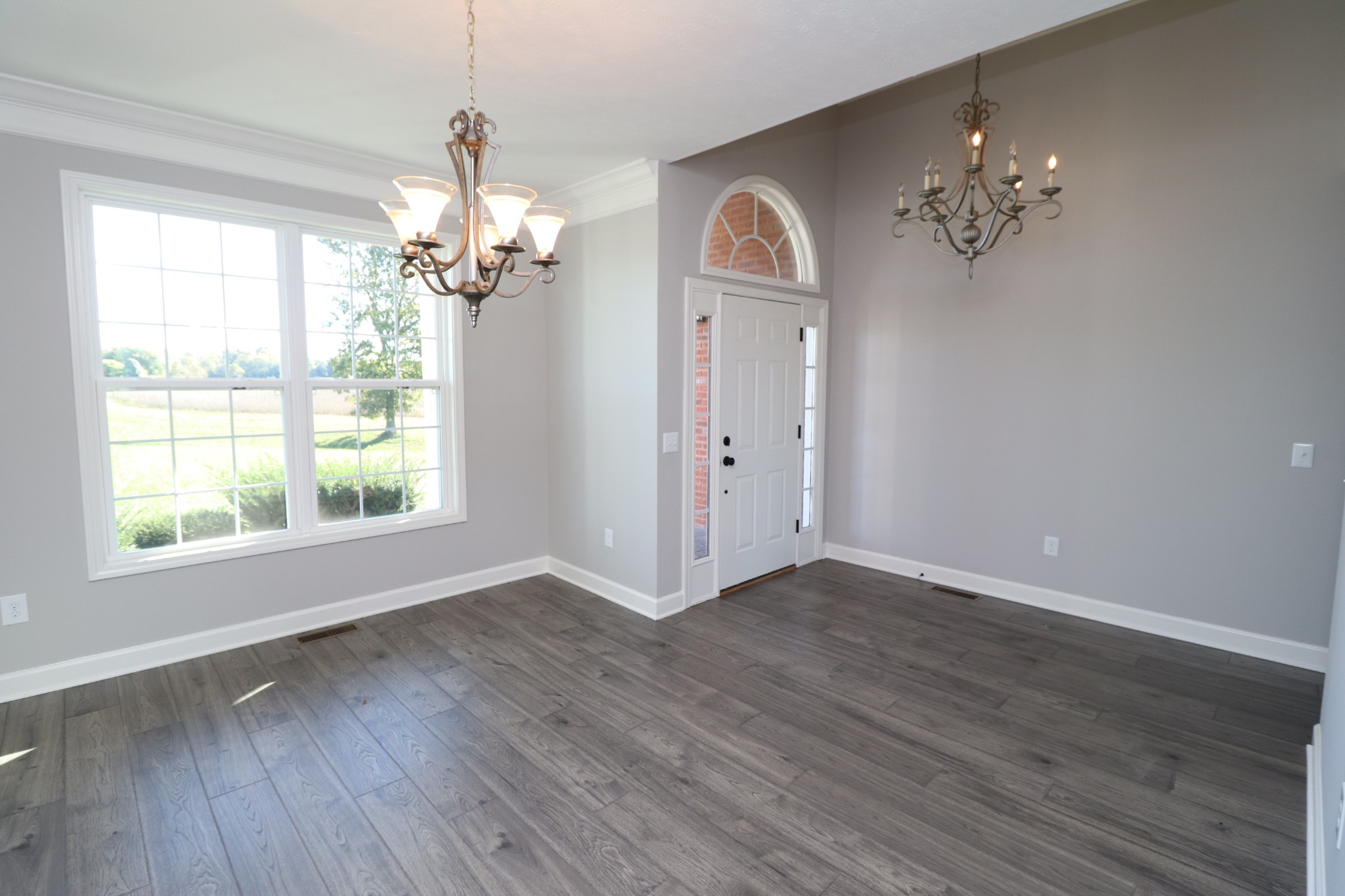 1180 Coleytown Road Lafayette, TN 37083 - Photo 15 of 42 an empty room with wooden floor chandelier and windows