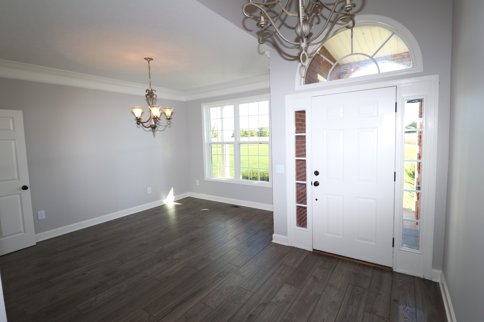 1180 Coleytown Road Lafayette, TN 37083 - Photo 16 of 42 an empty room with wooden floor chandelier and windows