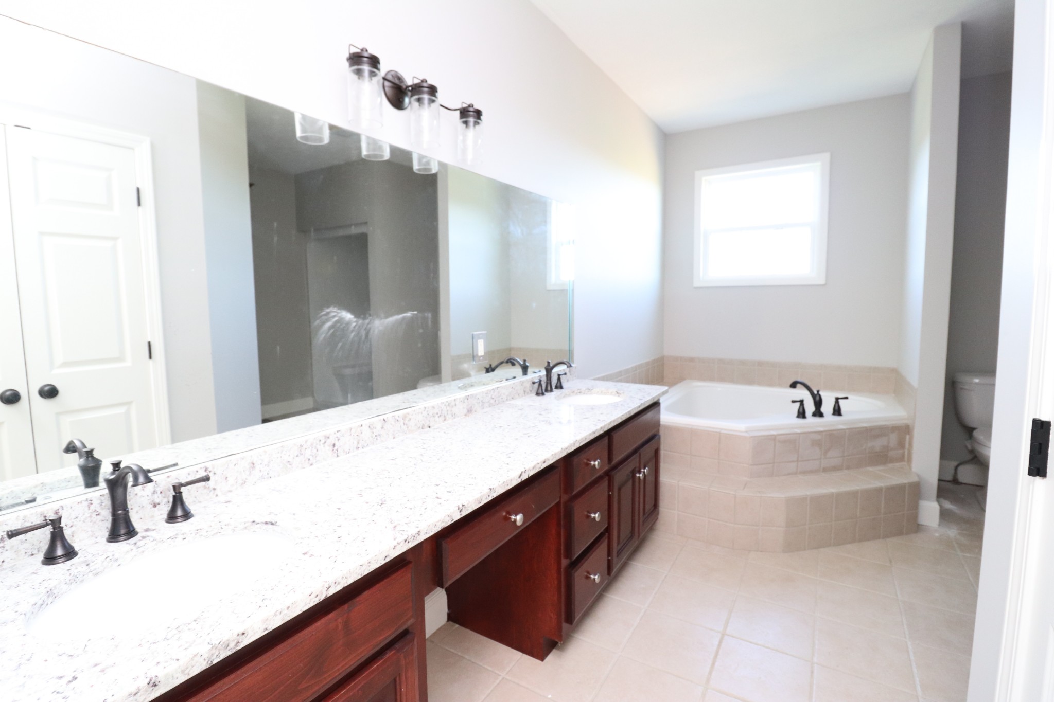 1180 Coleytown Road Lafayette, TN 37083 - Photo 19 of 42 a bathroom with a tub double vanity sink and mirror