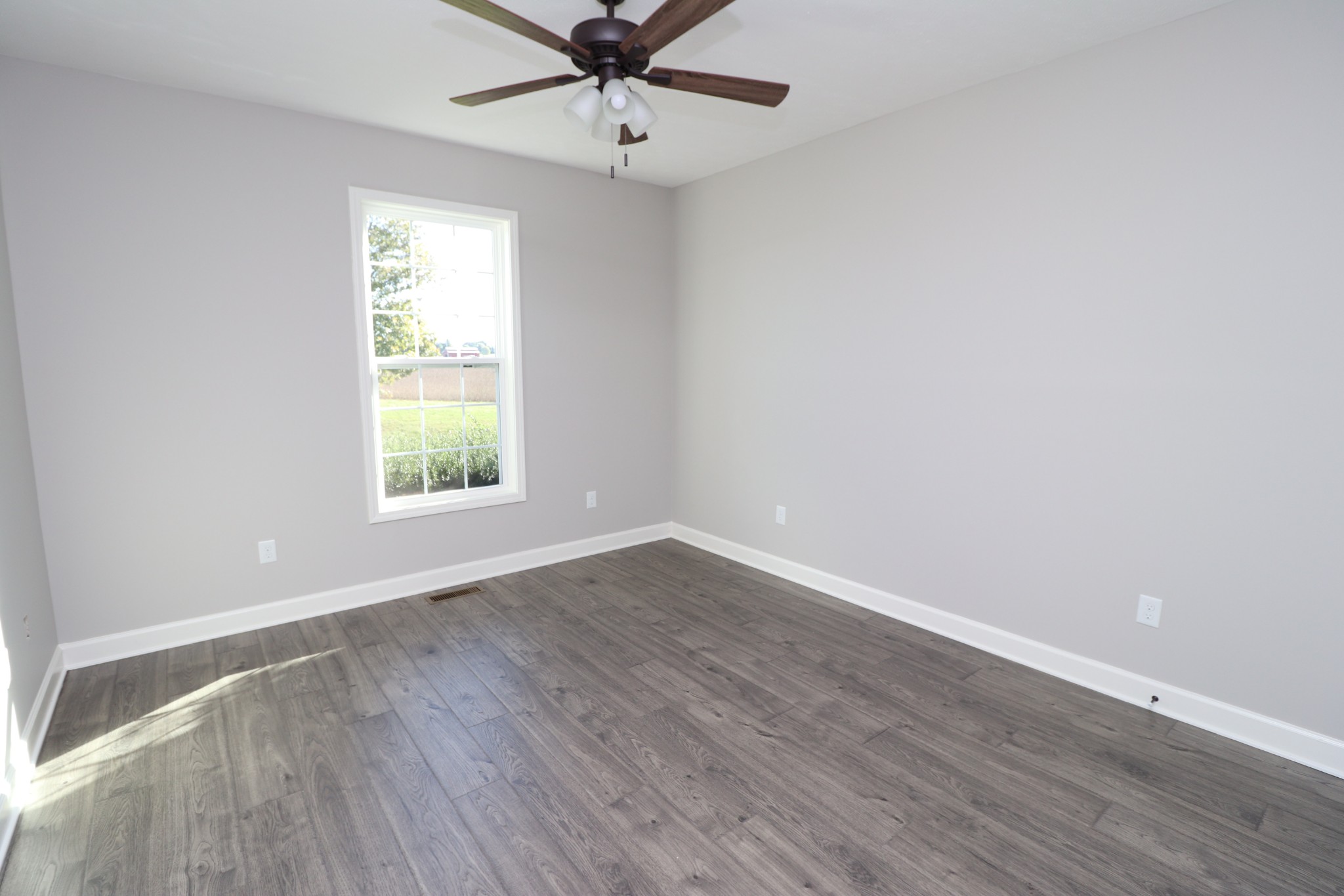 1180 Coleytown Road Lafayette, TN 37083 - Photo 26 of 42 an empty room with a window and a ceiling fan