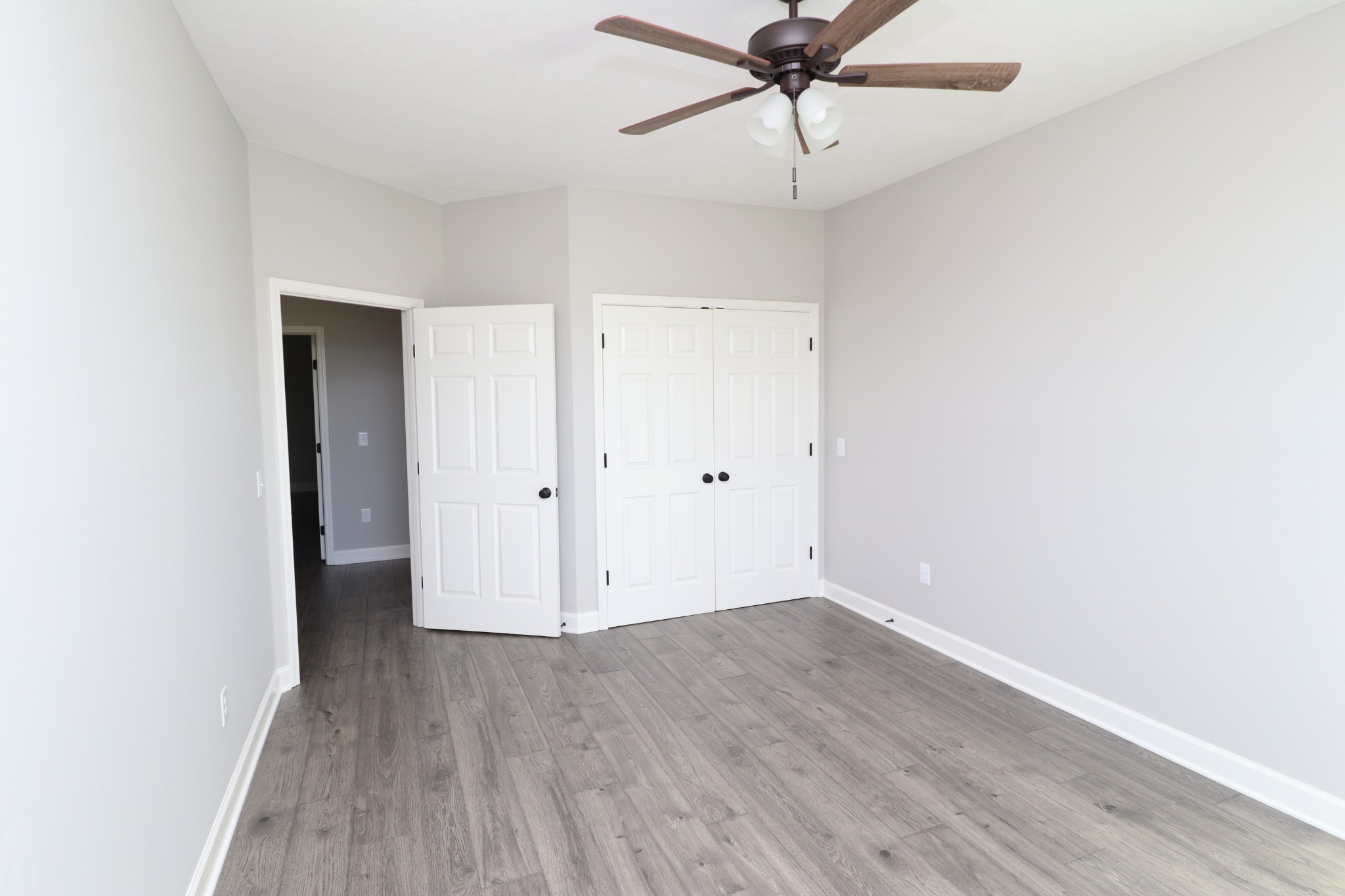 1180 Coleytown Road Lafayette, TN 37083 - Photo 27 of 42 an empty room with wooden floor and ceiling fan