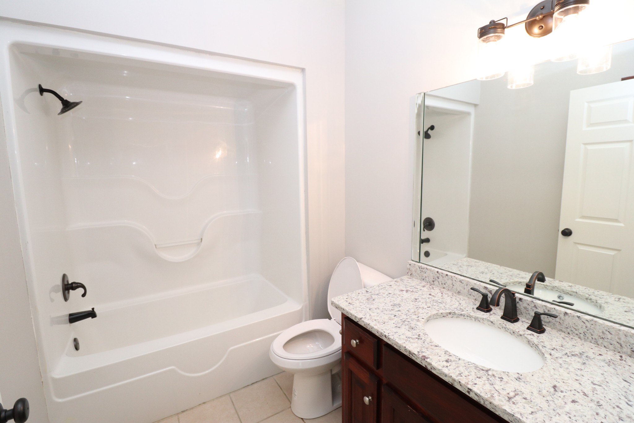 1180 Coleytown Road Lafayette, TN 37083 - Photo 28 of 42 a bathroom with a granite countertop sink a toilet and shower