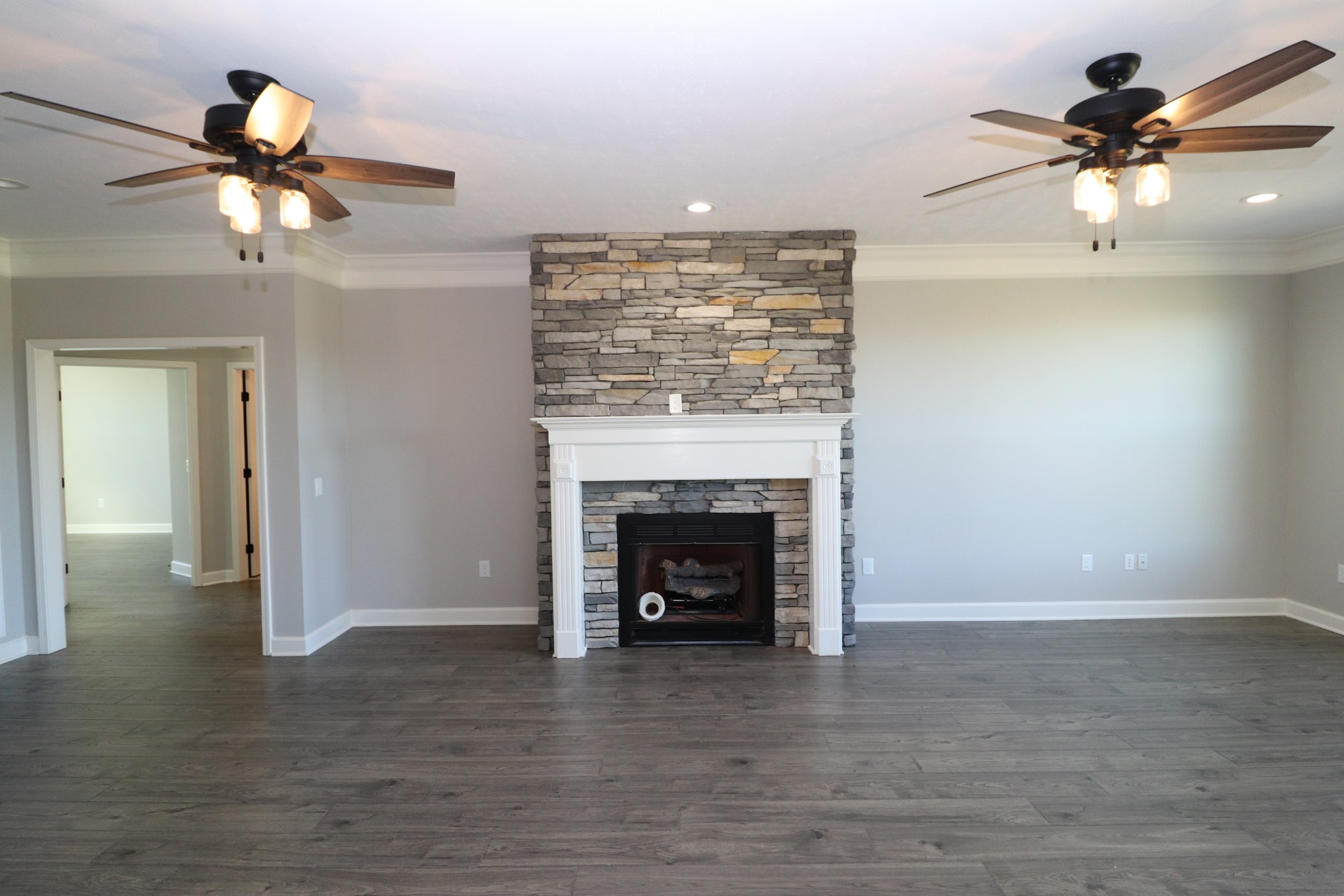 1180 Coleytown Road Lafayette, TN 37083 - Photo 7 of 42 a view of a livingroom with a fireplace and a ceiling fan