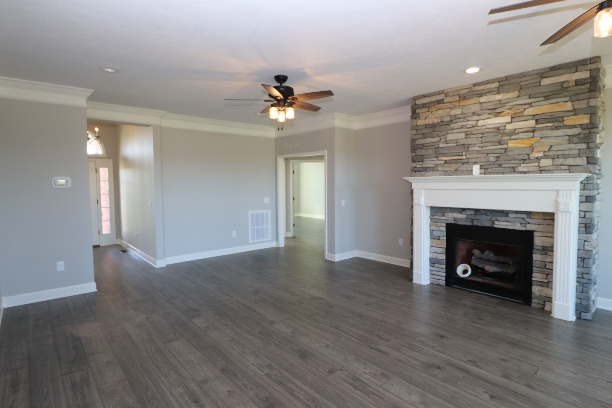 1180 Coleytown Road Lafayette, TN 37083 - Photo 8 of 42 a view of an empty room with wooden floor fireplace and a window