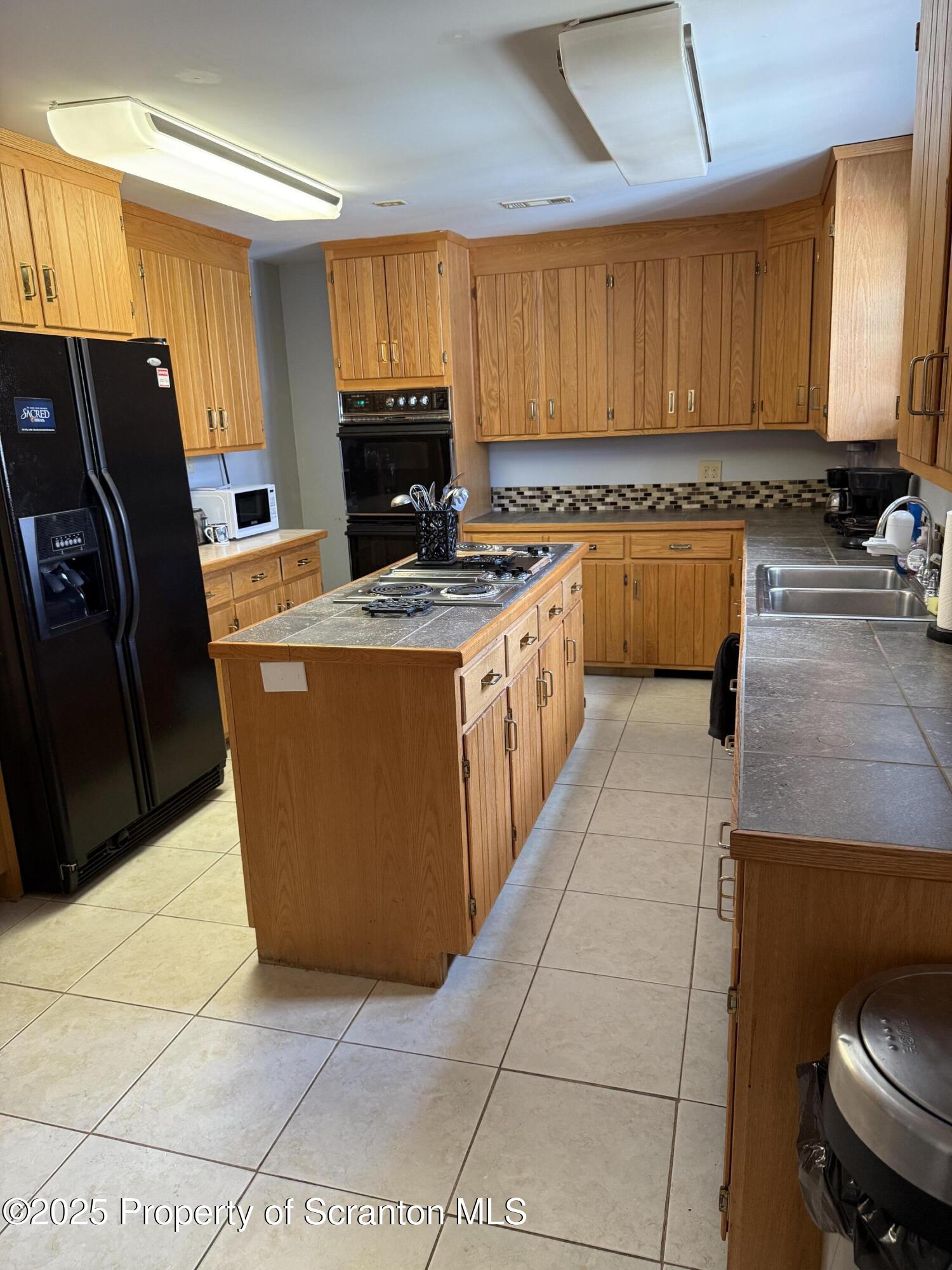 115 Taroli Street, Unit L20 22 Old Forge, PA 18518 - Photo 3 of 23 a kitchen with stainless steel appliances granite countertop a stove a refrigerator a sink a counter top space and cabinets