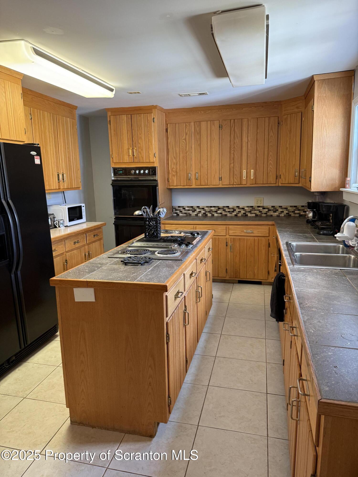 115 Taroli Street, Unit L20 22 Old Forge, PA 18518 - Photo 4 of 23 a kitchen with stainless steel appliances granite countertop a stove a sink and a refrigerator