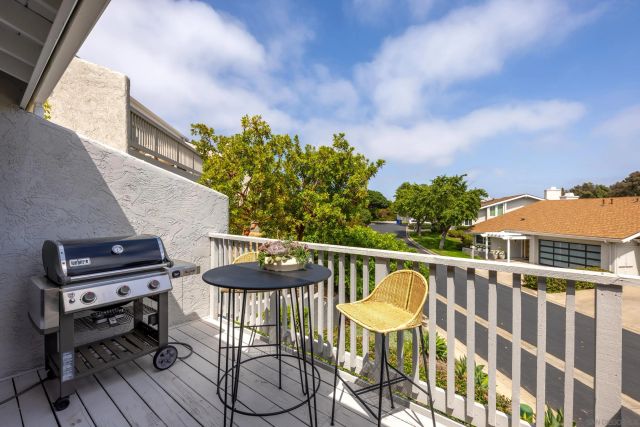a balcony with table and chairs