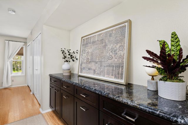 a kitchen with granite countertop a sink a plant and a window