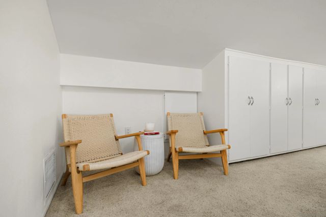 a bed room with a table chair and white door