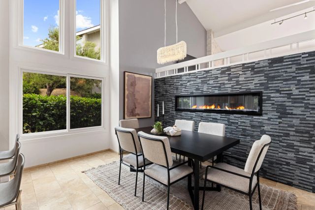 a balcony with furniture and a fireplace