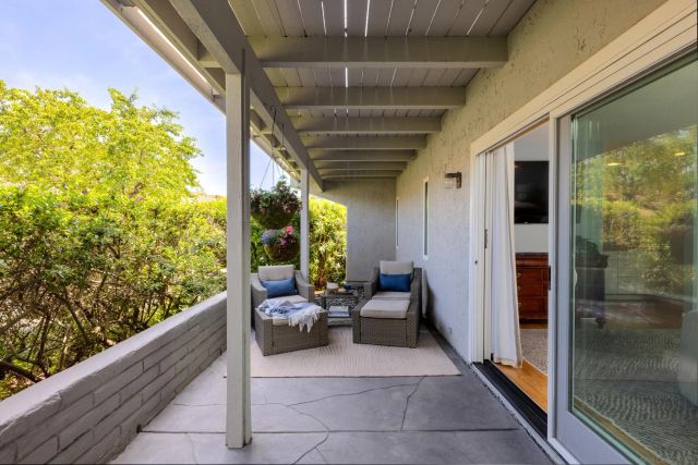 a balcony with furniture and a potted plant