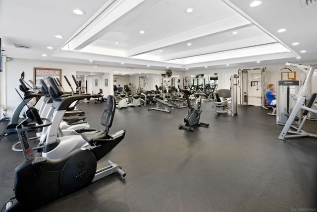 a front view of a building with a garden and plants