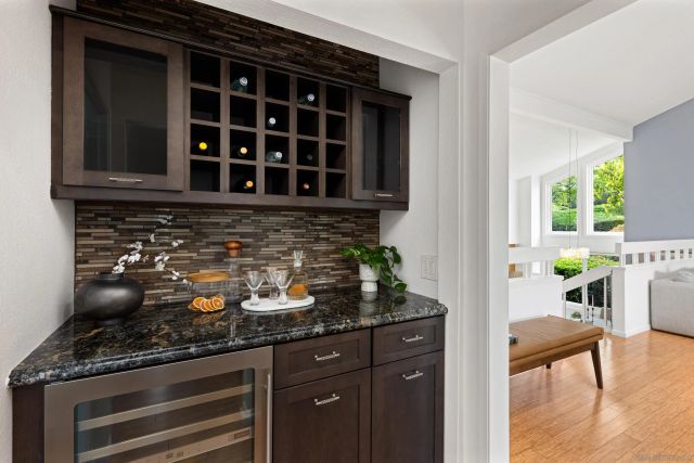 a kitchen with granite countertop a stove and cabinets