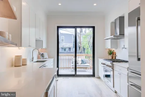 a kitchen with stainless steel appliances a sink a stove and a refrigerator